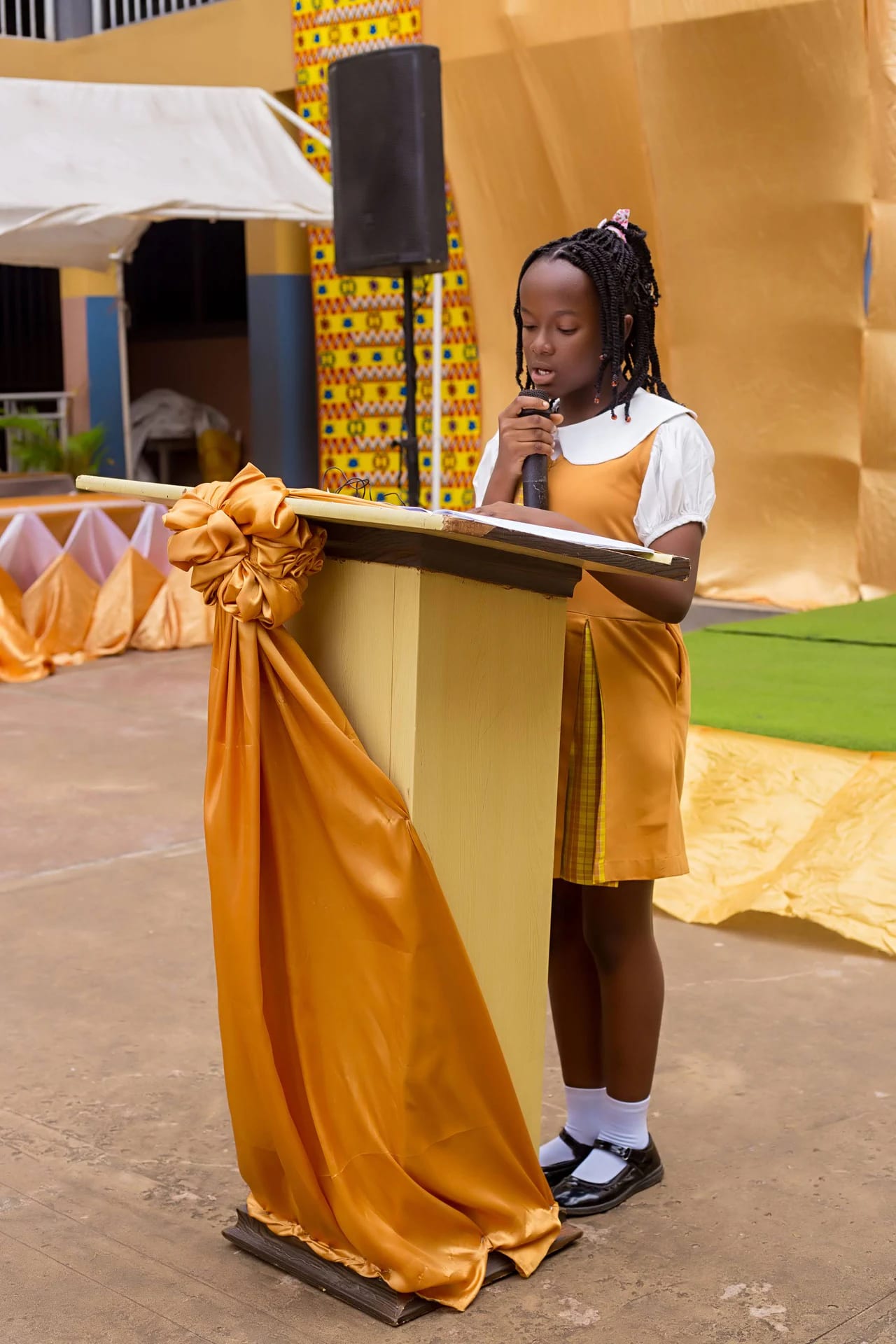 A Divine International School recital moment: student speaker.