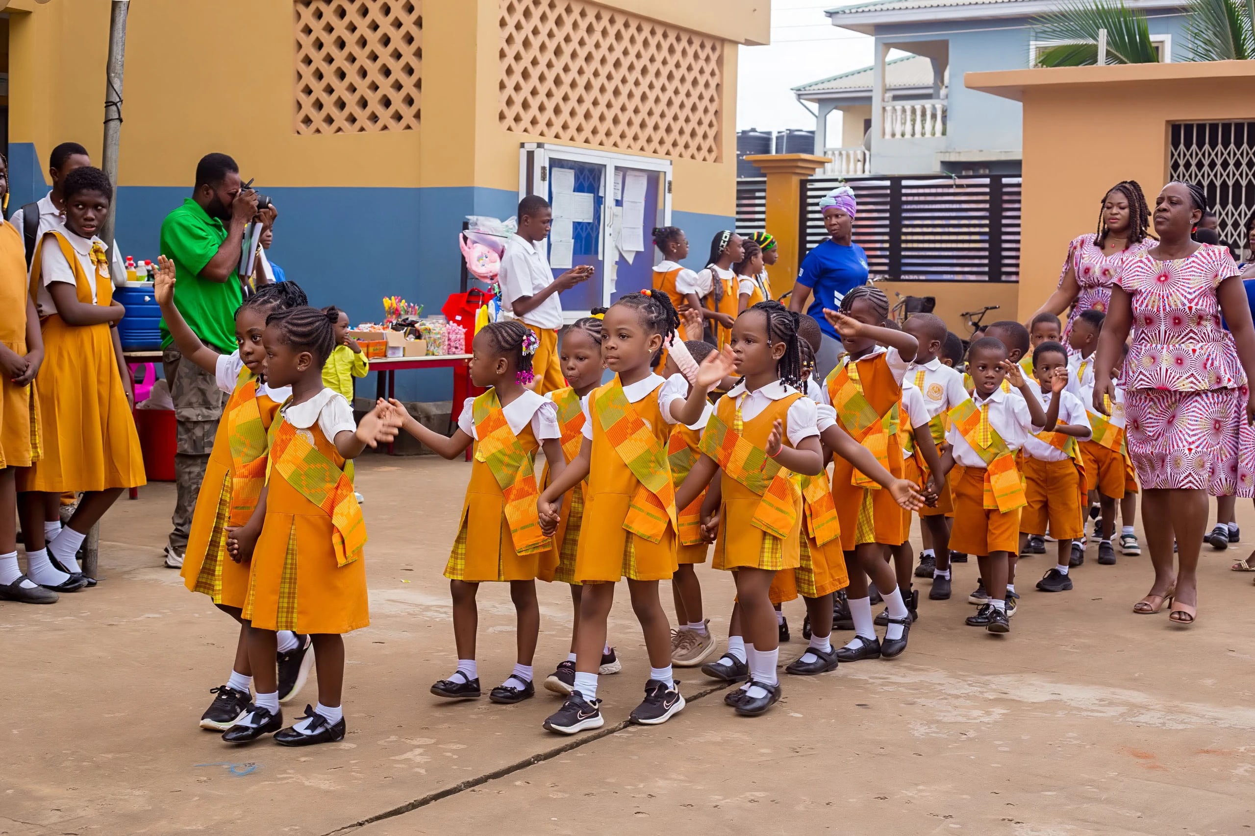Divine International School pupils during graduation: early learners walk up.