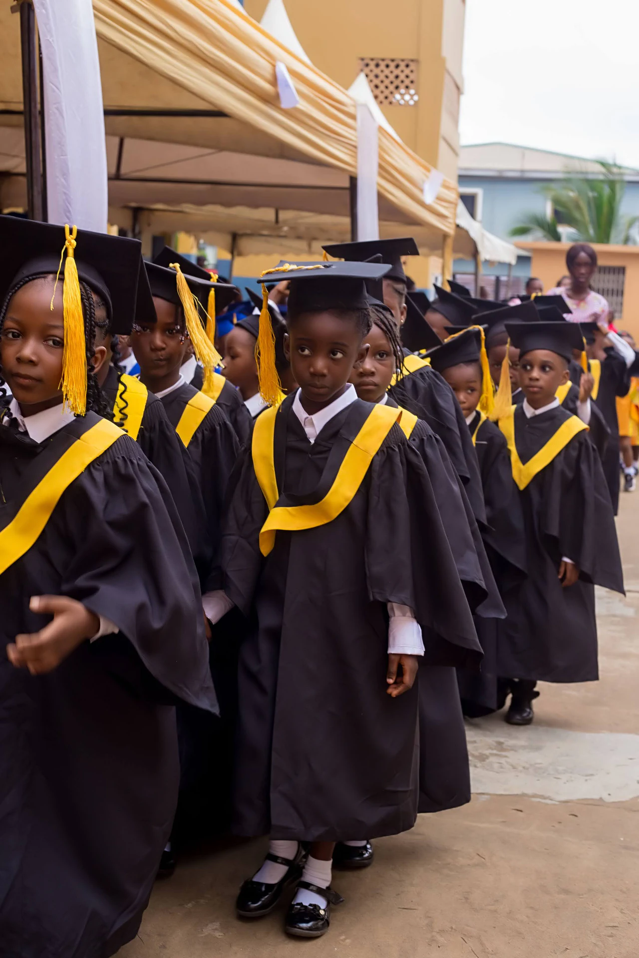 Divine International School pupils during graduation: kg walk up close up.